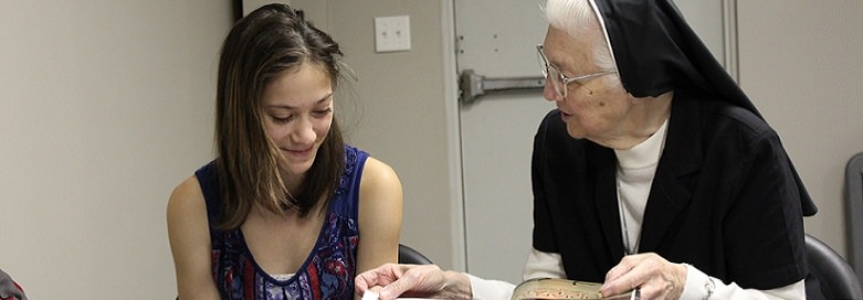 Sister Mary George Kissel teaches a student.