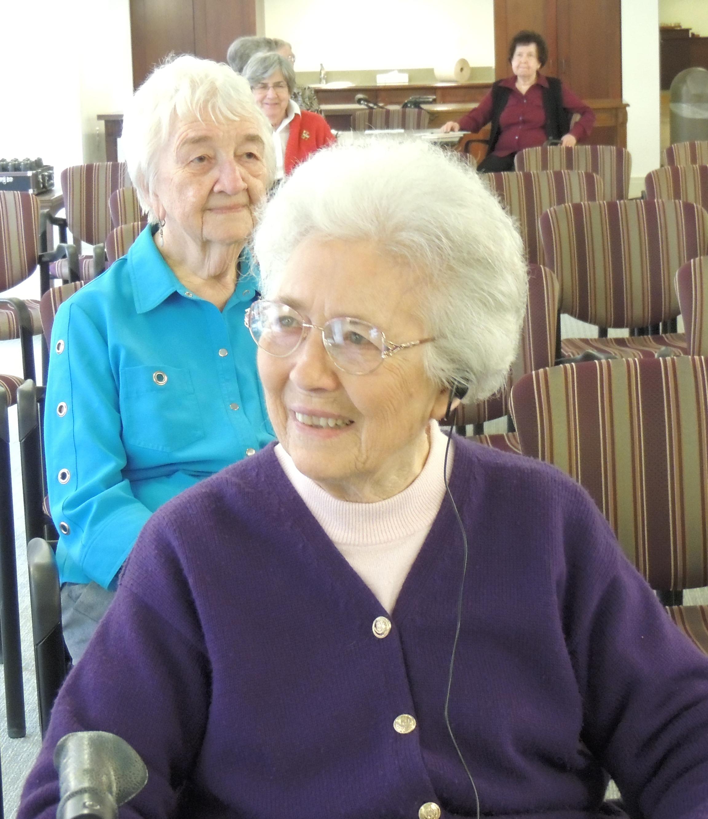 Sister Eileen Houlihan tries out the new assistive listening devices. 