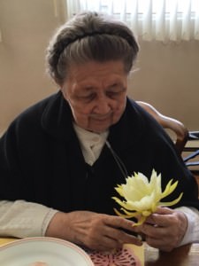 Sister Maria Elena holding a flower